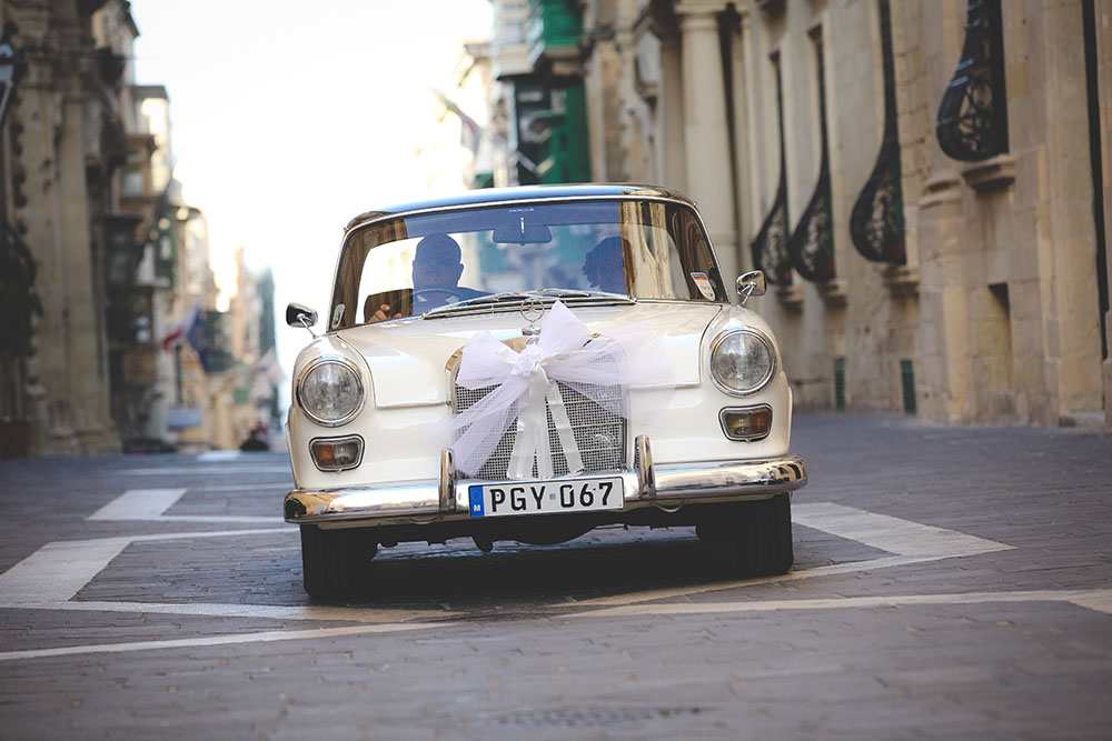 A vintage Percius bridal car on a Valletta street